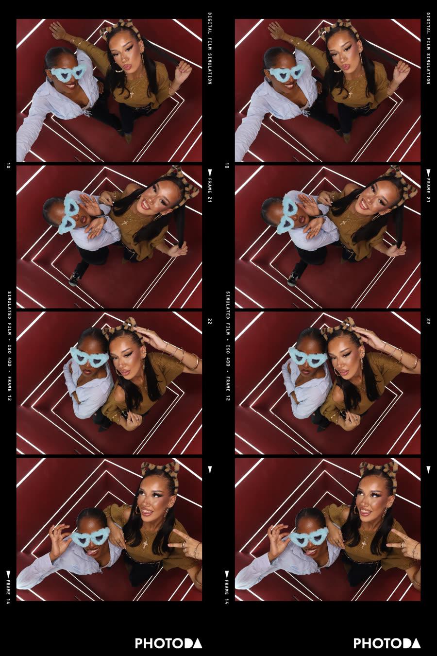 A real PhotoDA photo strip of two friends in the Neon Room on a black frame